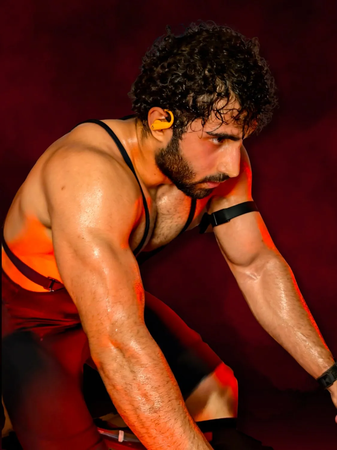 Training portrait under red light, upper body under load.